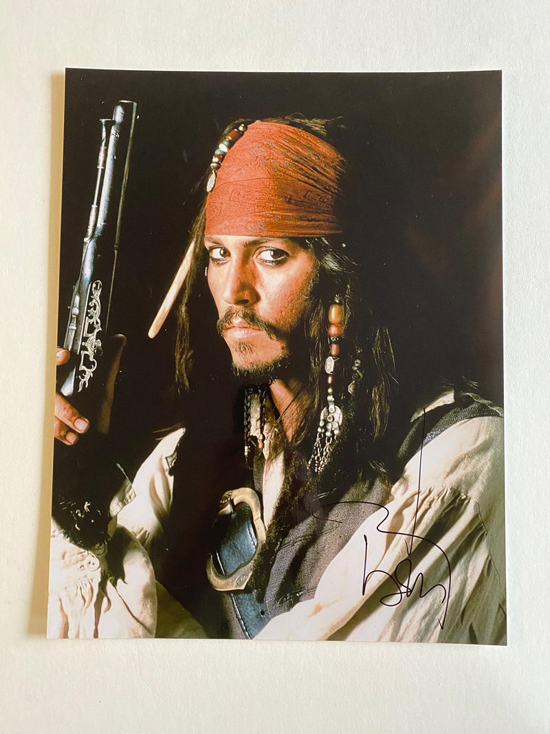 JOHNNY DEPP autographed "Pirates of the Caribbean" 11x14 photo